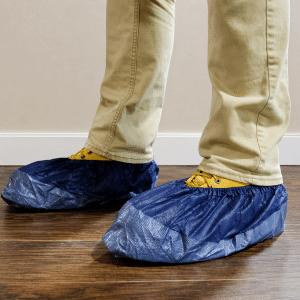 Blue Shoe Covers on wood flooring