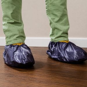Blue Shoe Covers On Hard Wood Floor