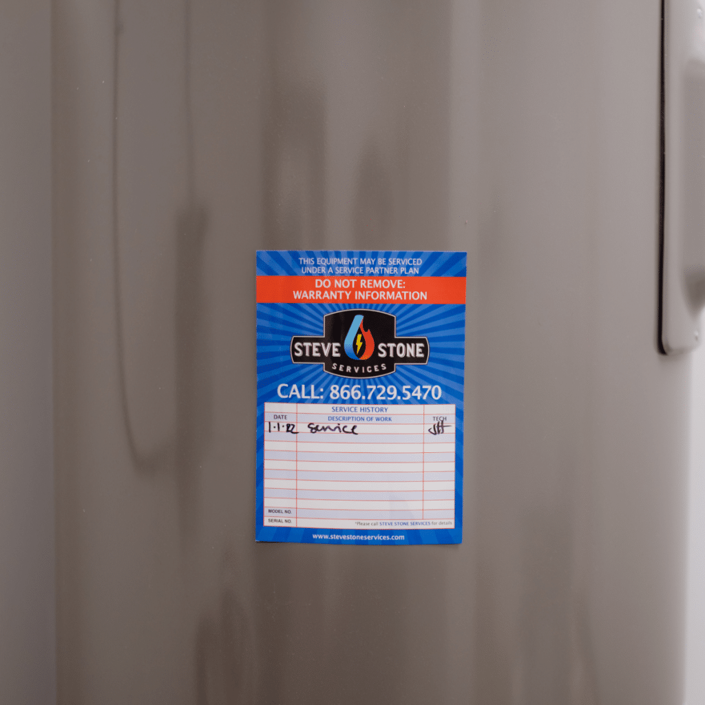 HVAC service history warranty indoor sticker applied to equipment with handwritten maintenance record