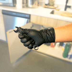 Black Gauntlet Gold Glove Holding Wrench