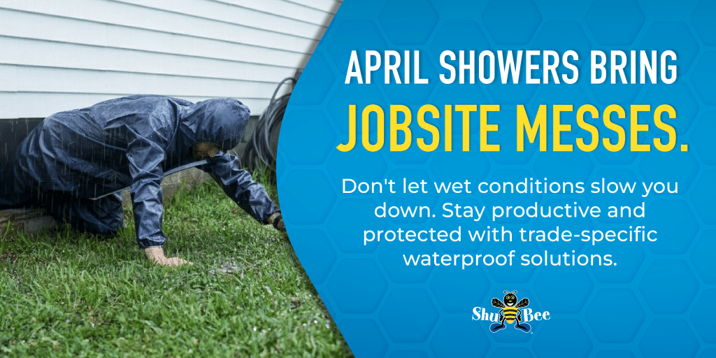 Worker in a hooded waterproof suit kneeling in wet grass during rainfall beside a house, highlighting protection from wet jobsite conditions